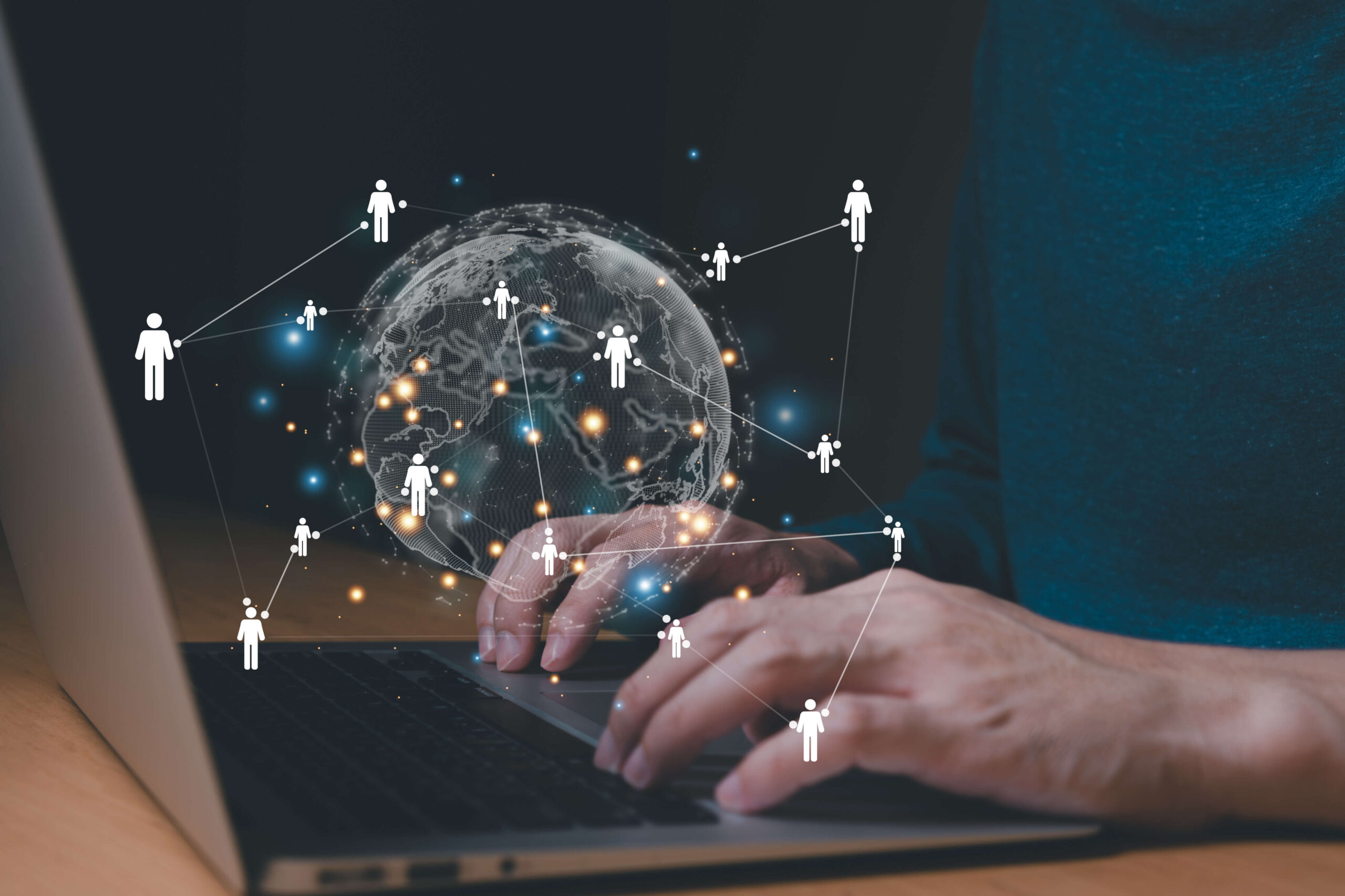 hands typing at laptop keyboard