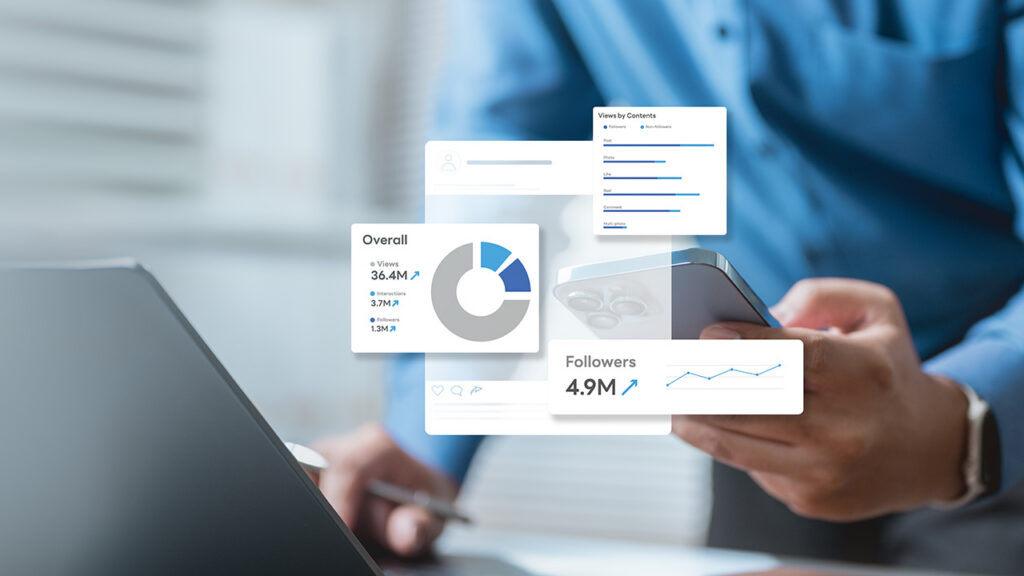 Person looking at their phone while using a laptop with search ad statistics appear over the phone